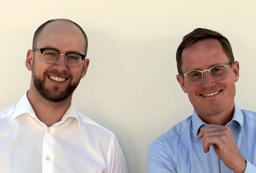 Two men smiling