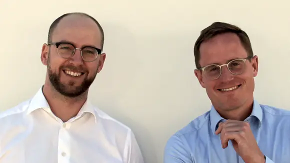 Two men smiling